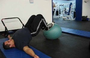 man exercising with stability ball